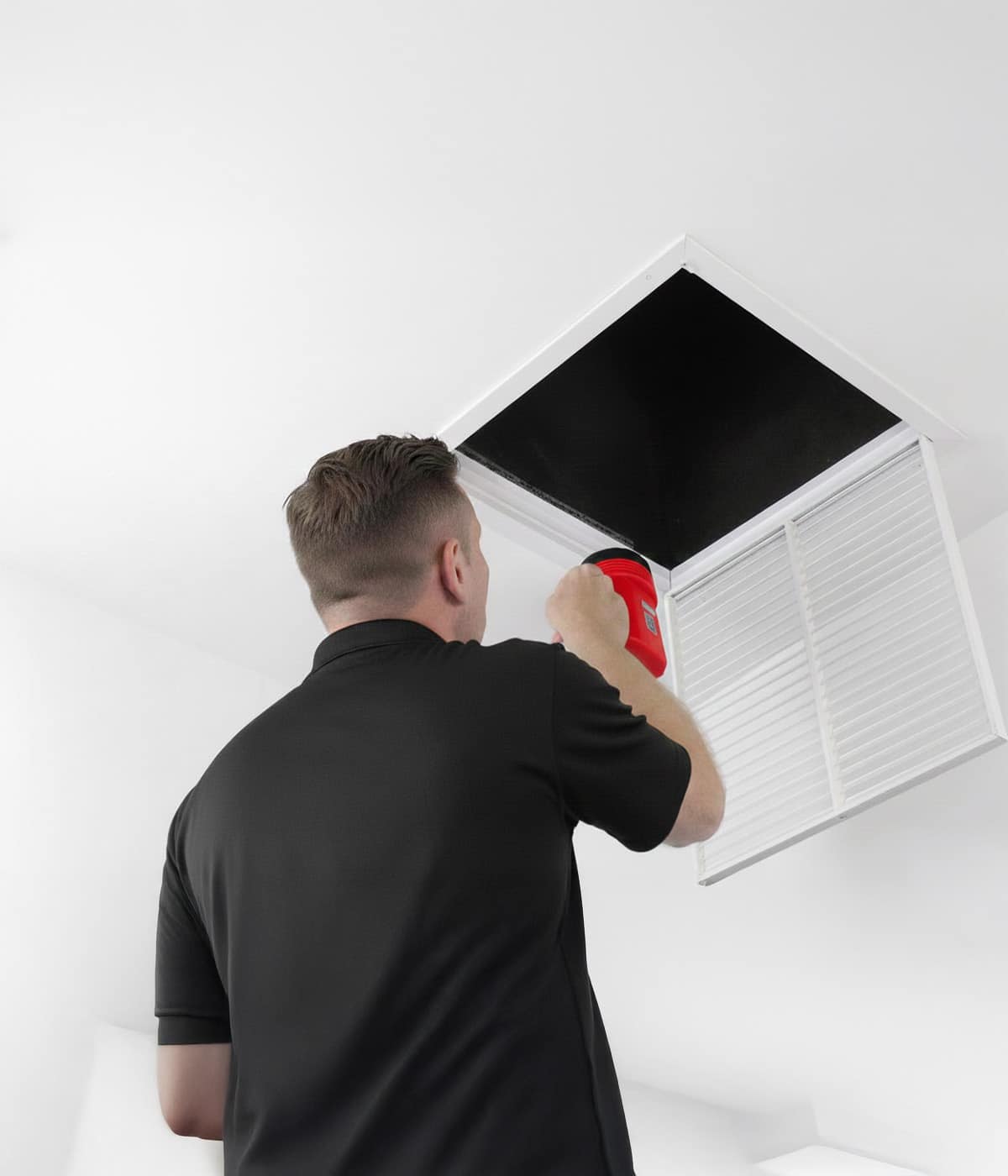 HVAC tech inspecting air vent